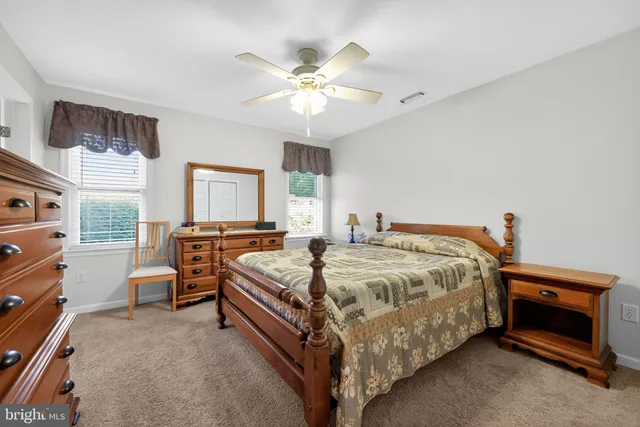 a spacious bedroom with a bed and a chandelier