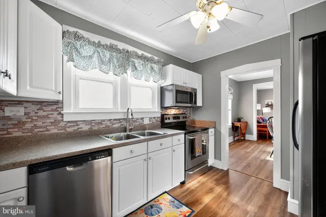 a kitchen with a sink stove and microwave