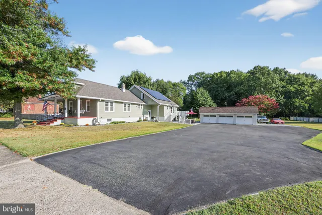 a front view of a house with a garden and yard