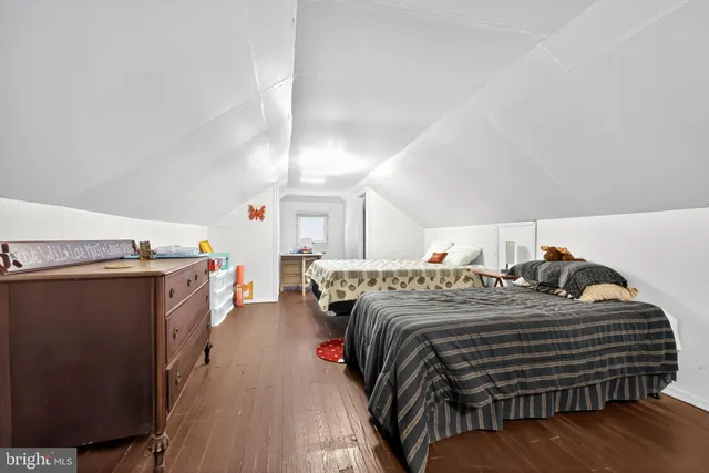 a bedroom with double bed and a dresser