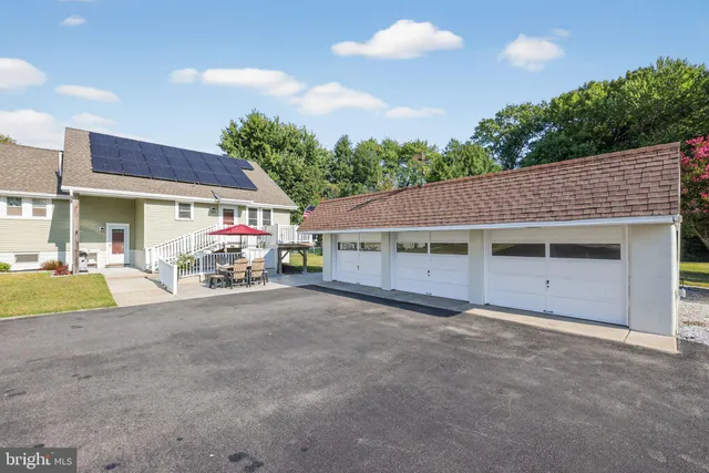 a view of a house with a patio and a yard