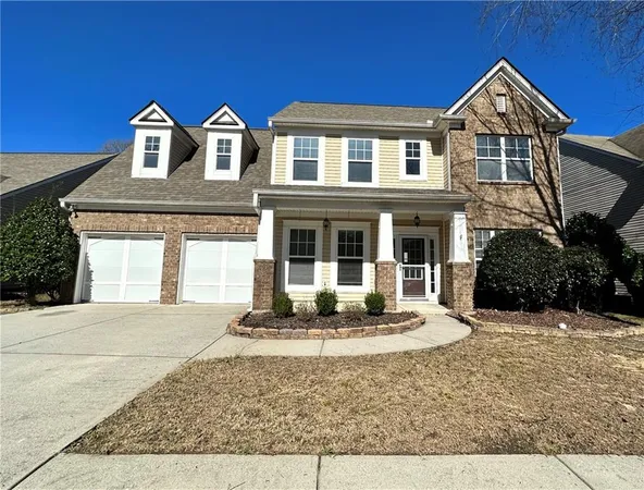 a front view of a house with a yard and porch