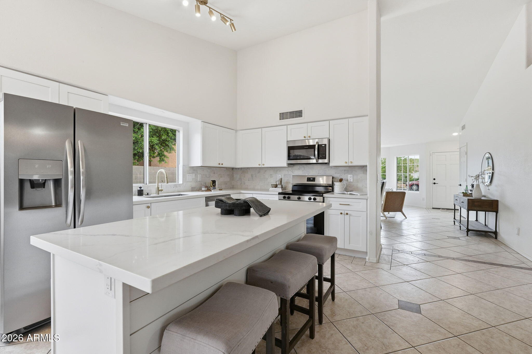7756 West Hearn Road Peoria, AZ 85381 - Photo 13 of 41 a kitchen with appliances a sink and cabinets