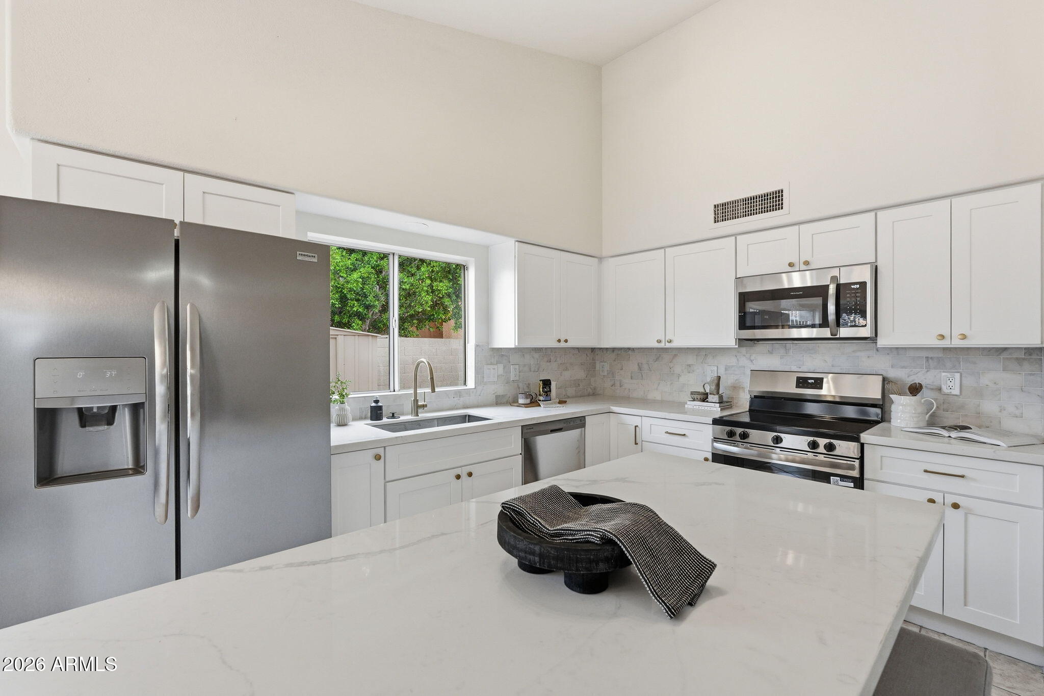 7756 West Hearn Road Peoria, AZ 85381 - Photo 14 of 41 a kitchen with stainless steel appliances a refrigerator stove microwave and sink