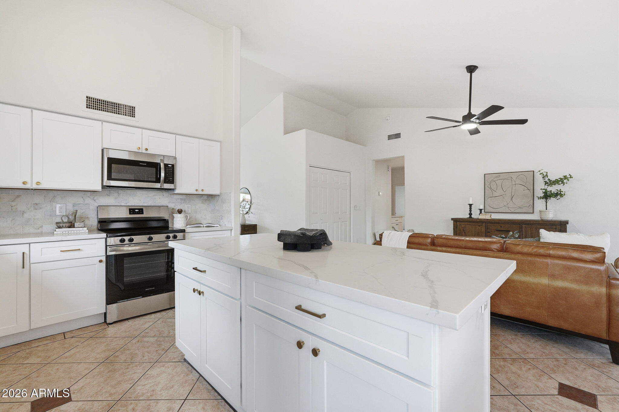 7756 West Hearn Road Peoria, AZ 85381 - Photo 15 of 41 a kitchen with stainless steel appliances white cabinets and a sink