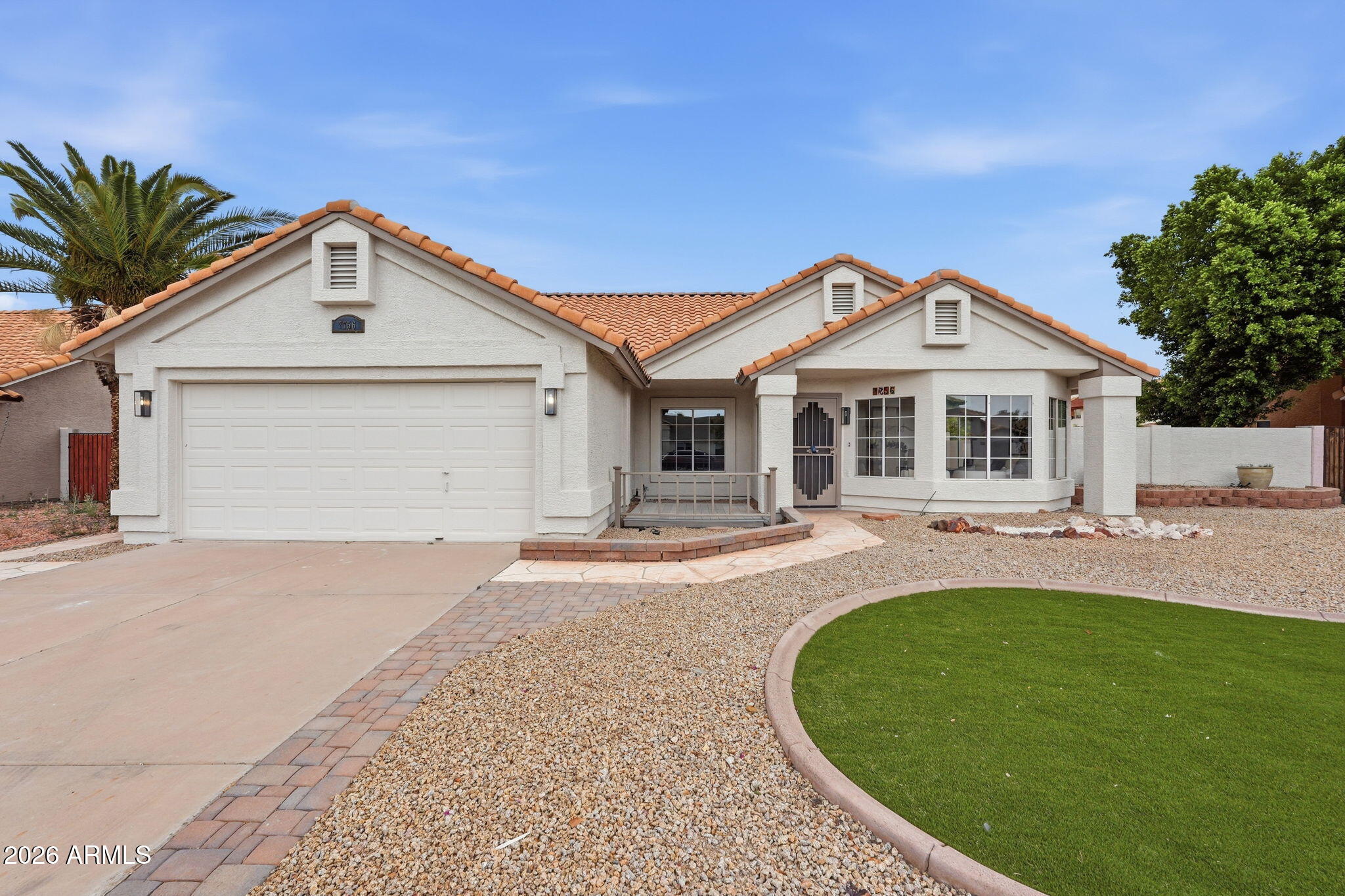 7756 West Hearn Road Peoria, AZ 85381 - Photo 2 of 41 a front view of a house with a yard and porch