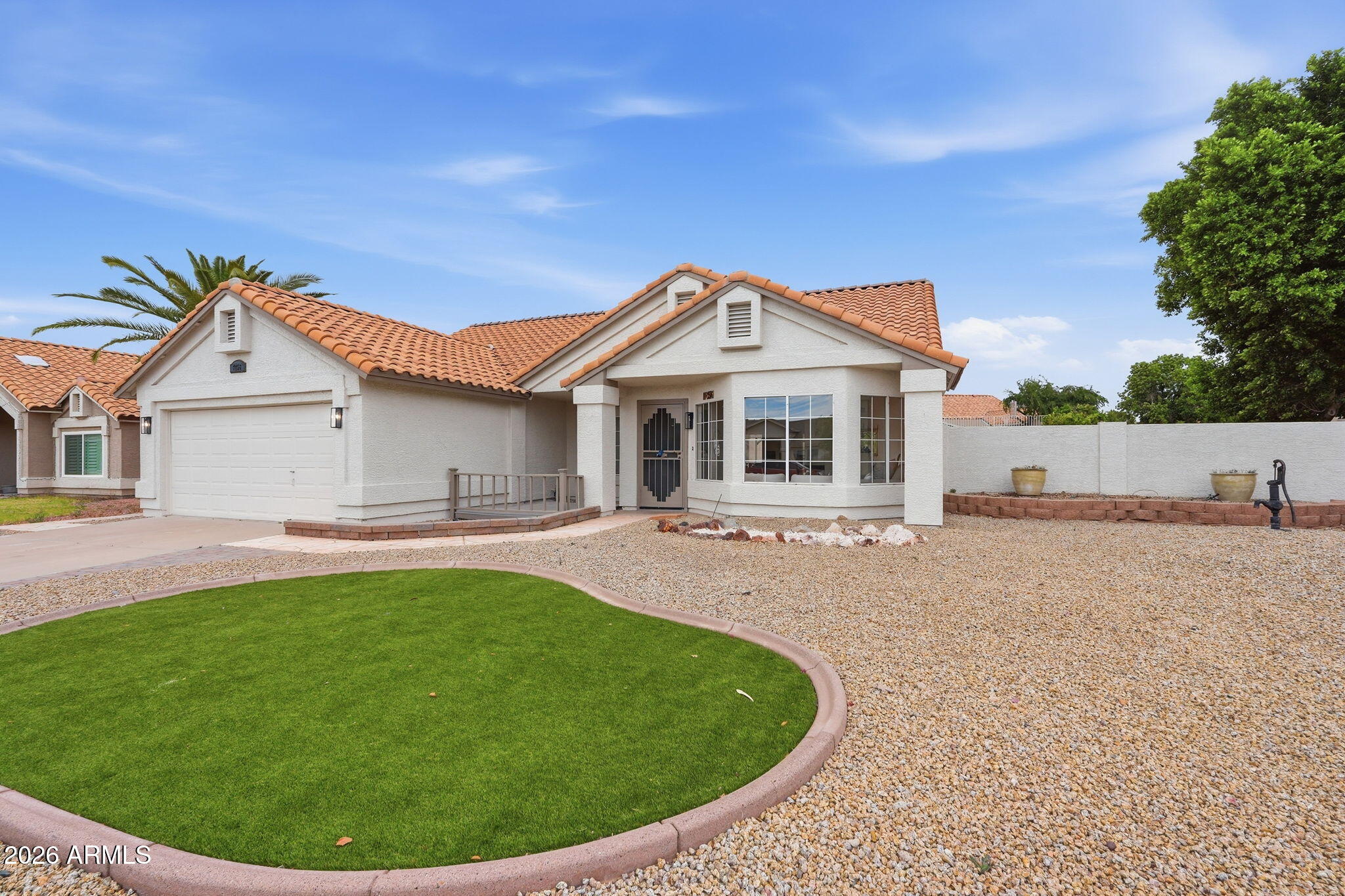 7756 West Hearn Road Peoria, AZ 85381 - Photo 3 of 41 a view of a house with a backyard and porch