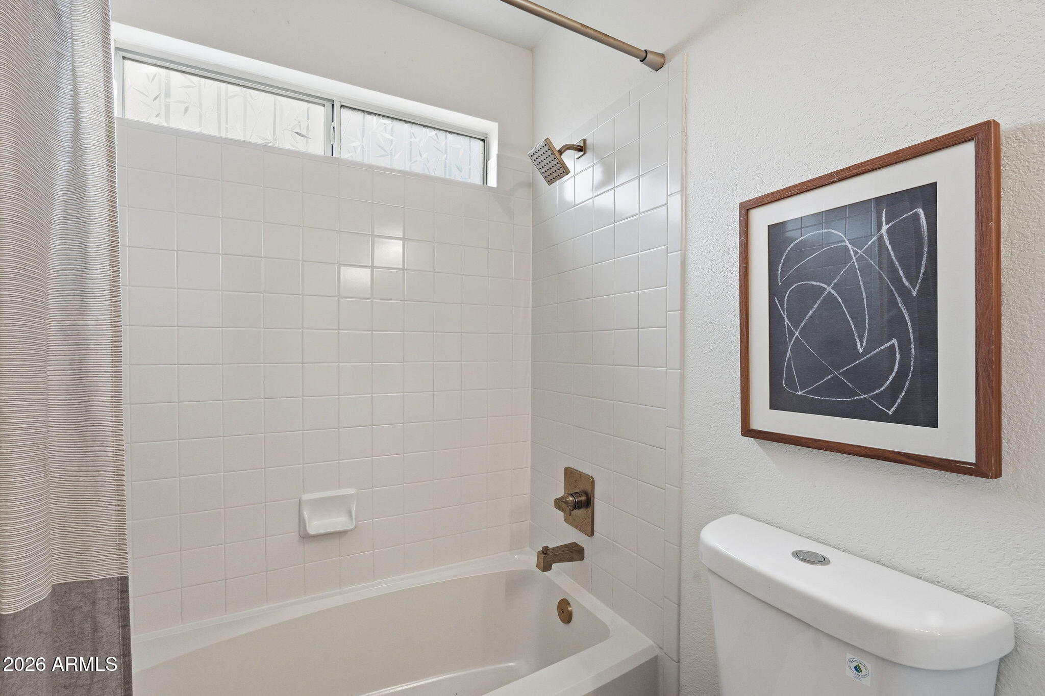 7756 West Hearn Road Peoria, AZ 85381 - Photo 34 of 41 a bathroom with a toilet a sink and a bathtub