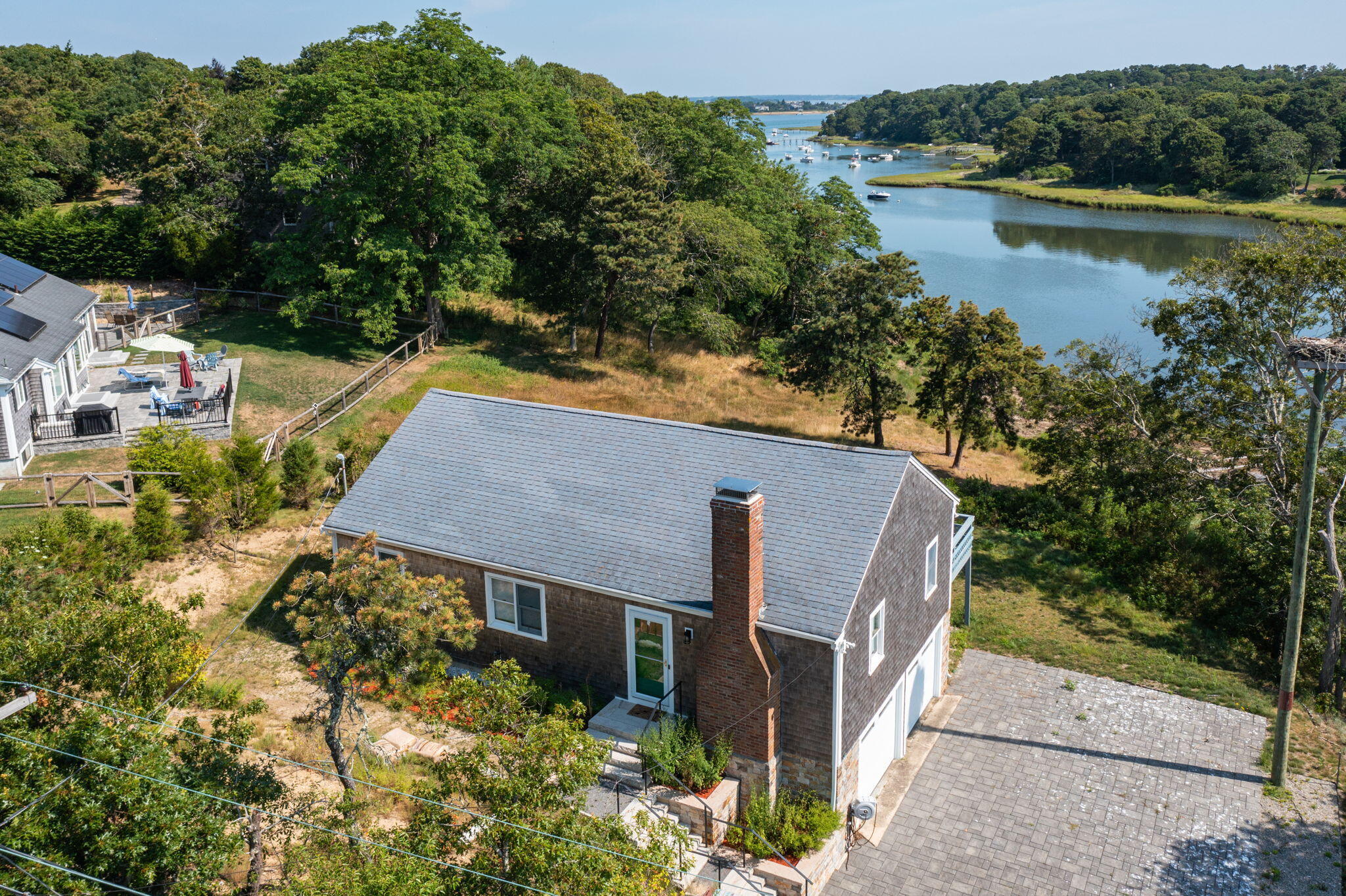 an aerial view of a house with a yard and lake view