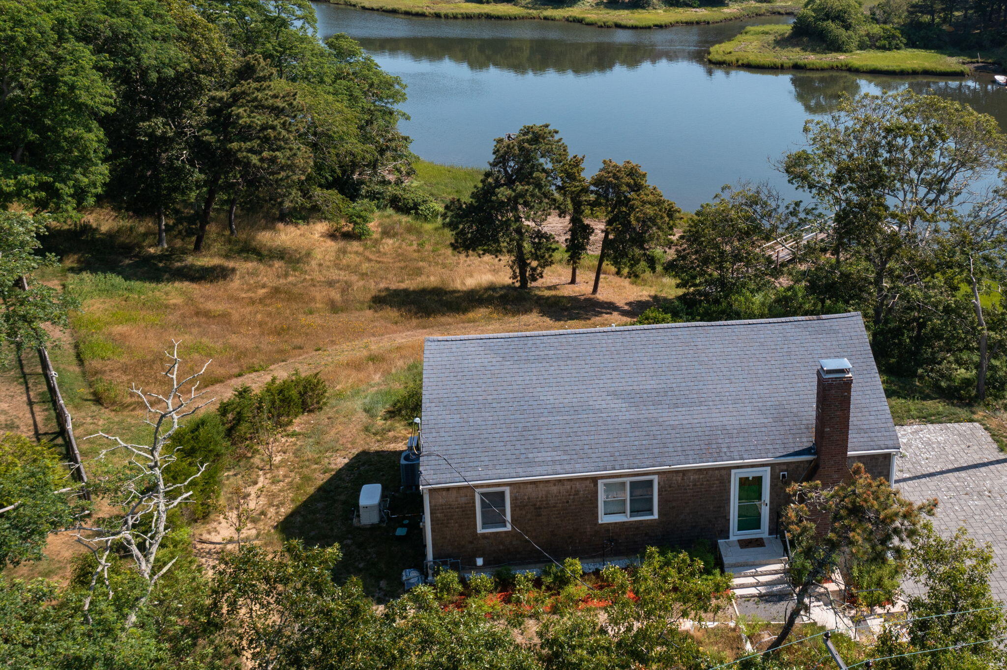 552 Orleans Road North Chatham, MA 02650 - Photo 2 of 31 an aerial view of a house with a yard and lake view
