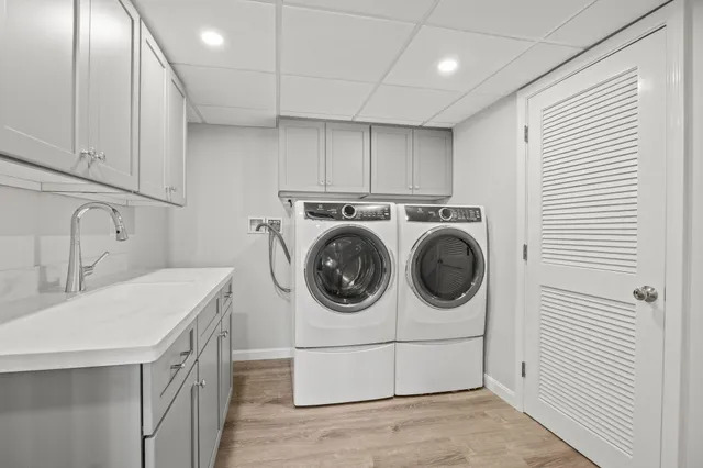 a utility room with sink dryer and washer