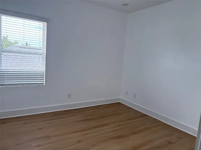 a view of a room with wooden floor and a sink