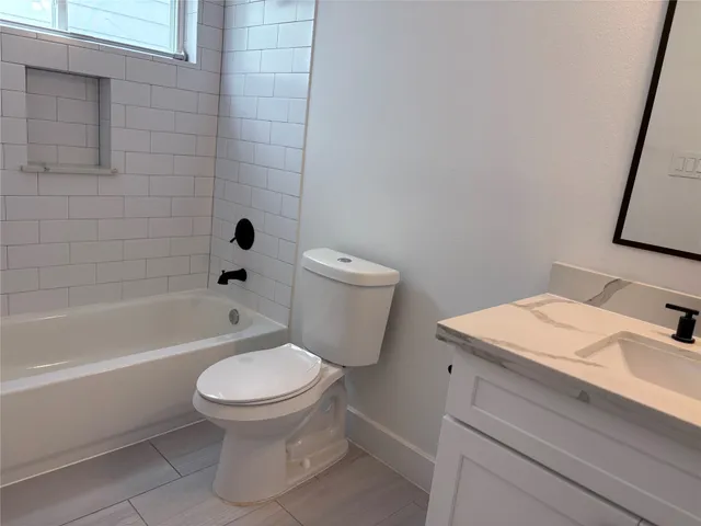 a bathroom with a toilet a sink and bathtub