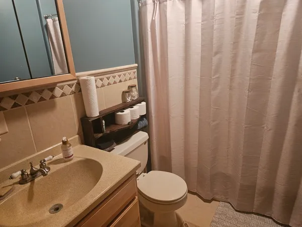 a bedroom with a bed and a chair