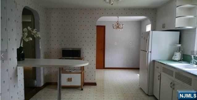 208 Columbus Place, Unit 2 Cliffside Park, NJ 07010 - Photo 4 of 9 a kitchen with stainless steel appliances granite countertop a refrigerator a stove and a sink