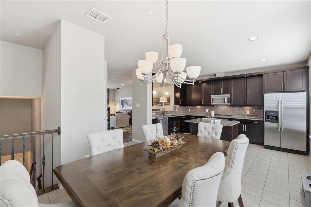 3941 Asbury Lane Addison, TX 75001 - Photo 13 of 30 a dining room filled chandelier and kitchen view