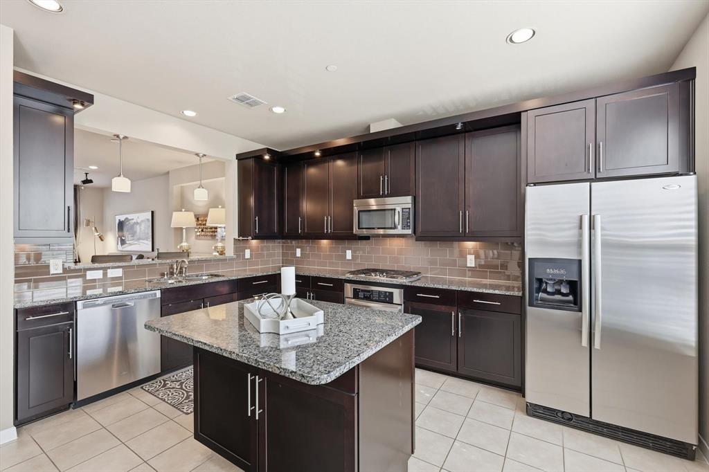3941 Asbury Lane Addison, TX 75001 - Photo 16 of 30 a kitchen with a sink stainless steel appliances and cabinets