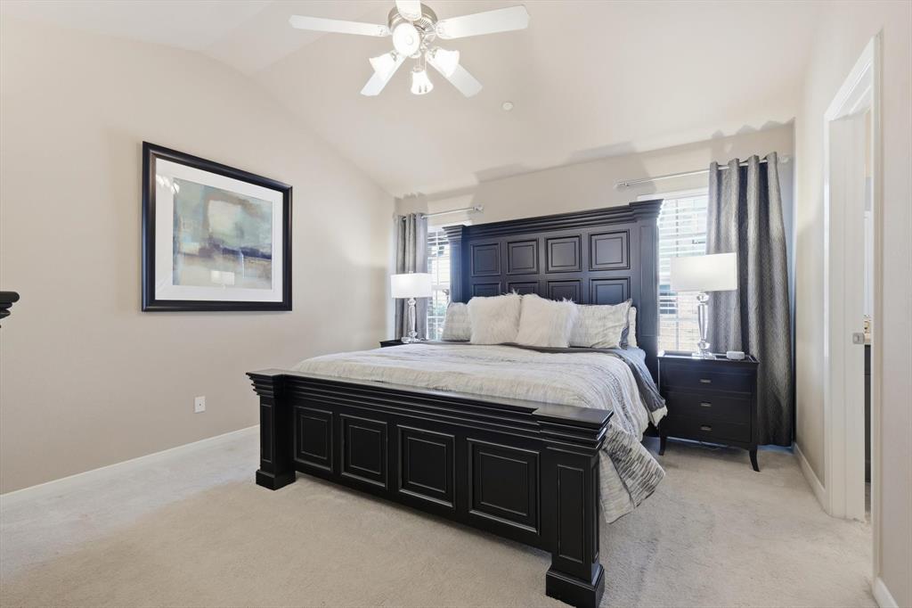 3941 Asbury Lane Addison, TX 75001 - Photo 18 of 30 a bedroom with a bed and a chandelier