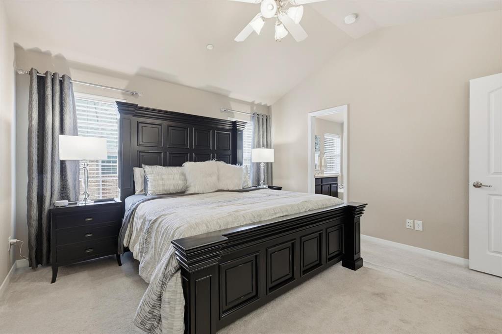 3941 Asbury Lane Addison, TX 75001 - Photo 19 of 30 a bedroom with a bed and a chandelier