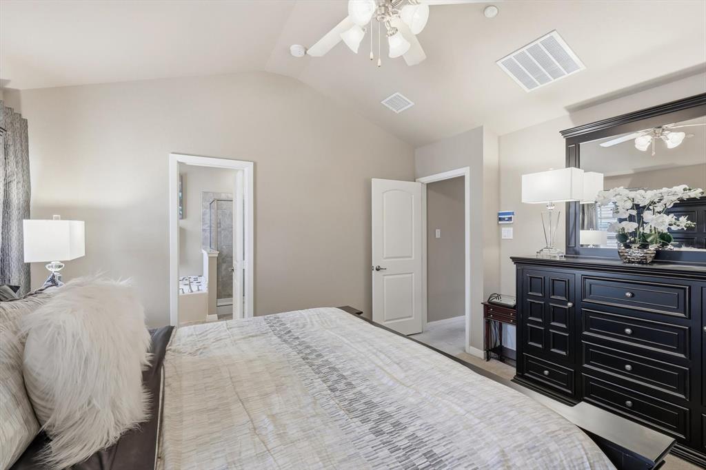 3941 Asbury Lane Addison, TX 75001 - Photo 20 of 30 a bedroom with a bed and a chandelier
