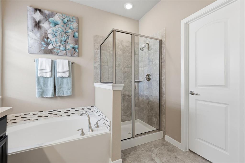 3941 Asbury Lane Addison, TX 75001 - Photo 22 of 30 a bathroom with a bathtub and a shower