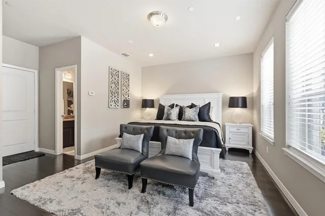a bathroom with a granite countertop toilet sink and mirror