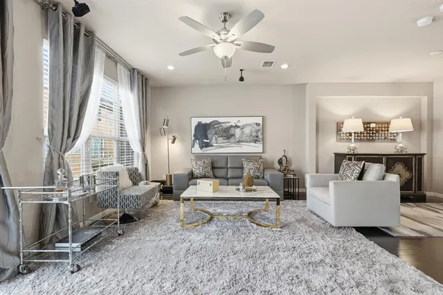 a living room with furniture a rug and white walls