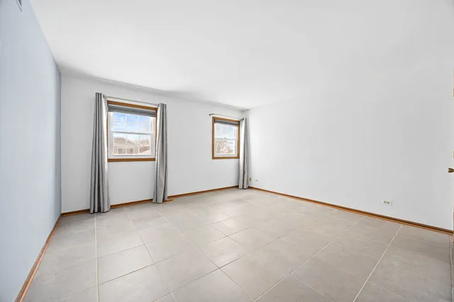 an empty room with windows and closet