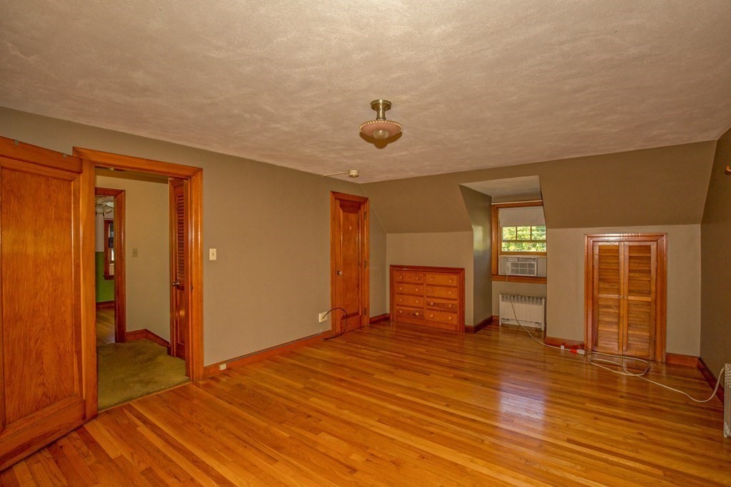 25 Belchertown Street Three Rivers, MA 01080 - Photo 22 of 32 an empty room with wooden floor and windows
