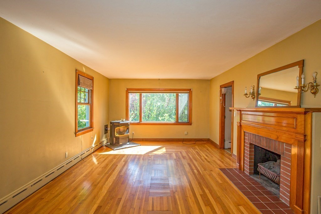 25 Belchertown Street Three Rivers, MA 01080 - Photo 8 of 32 a view of empty room with wooden floor and fireplace
