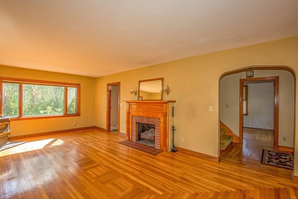 25 Belchertown Street Three Rivers, MA 01080 - Photo 9 of 32 a view of an empty room with a fireplace and a window