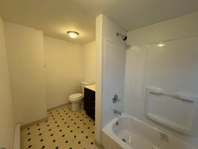 a bathroom with a bathtub and toilet