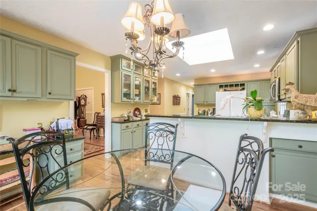 a view of a dining room with furniture and chandelier