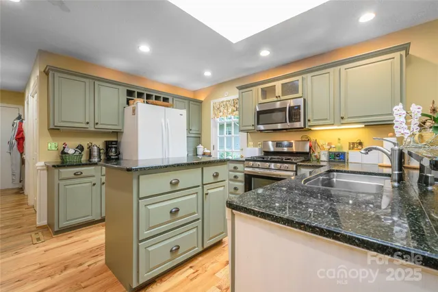 a kitchen with granite countertop a stove and a sink