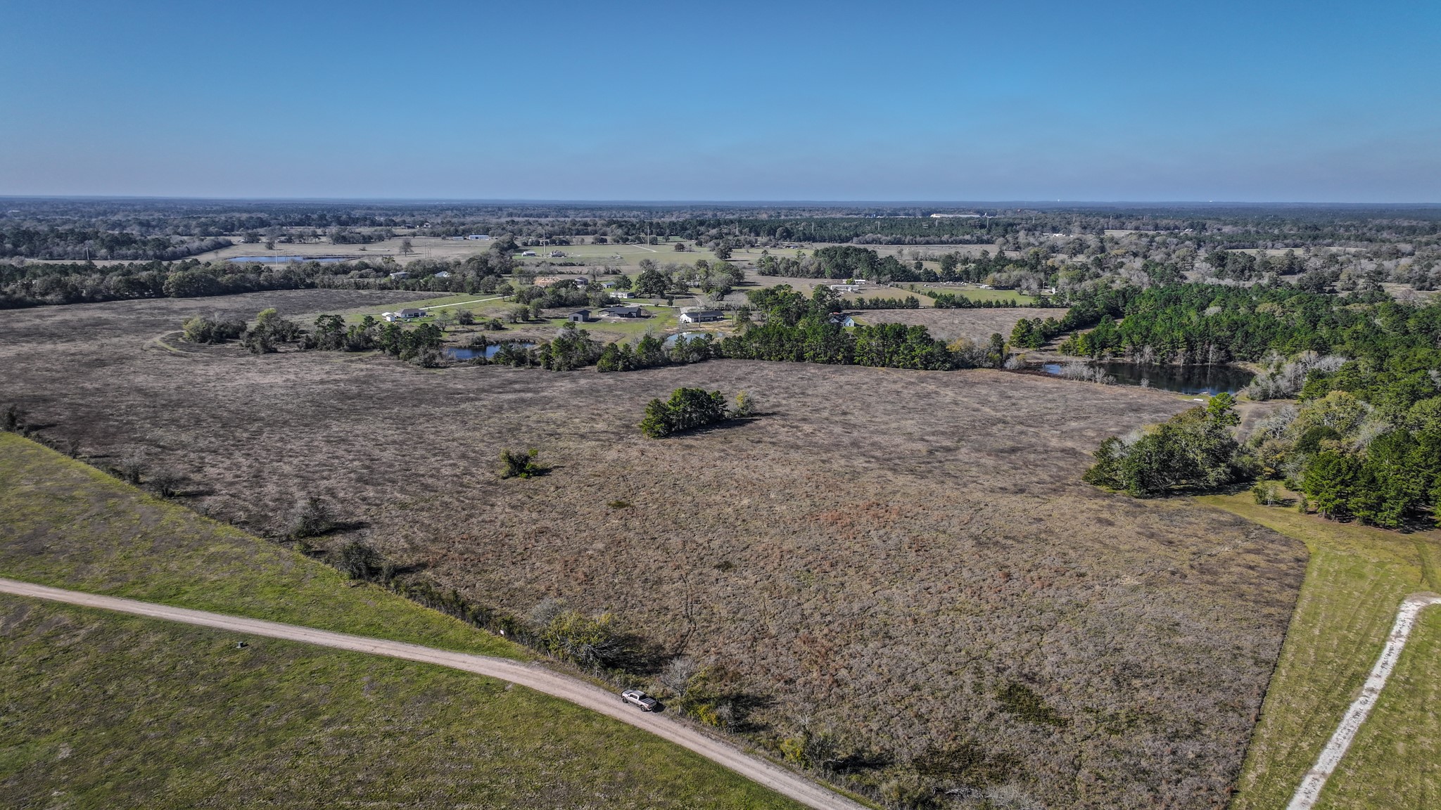 Tbd Lot 1-2 Tbd Road New Waverly, TX 77358 - Photo 16 of 29 a view of a dry yard with wooden fence