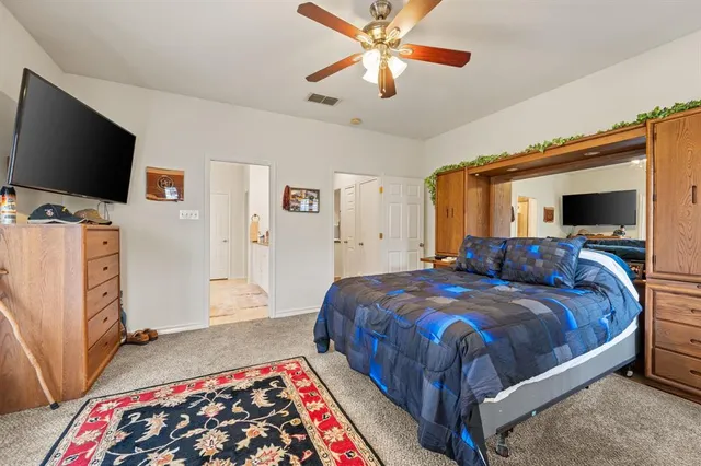 a bedroom with bed and flat screen tv
