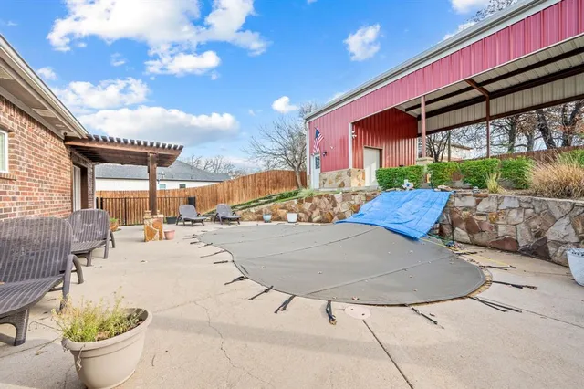 a view of a patio with swimming pool table and chairs