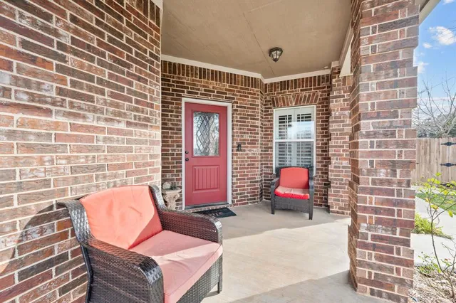 a outdoor space with patio couches and a fireplace
