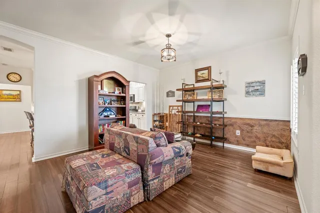 a bedroom with furniture and a wooden floor