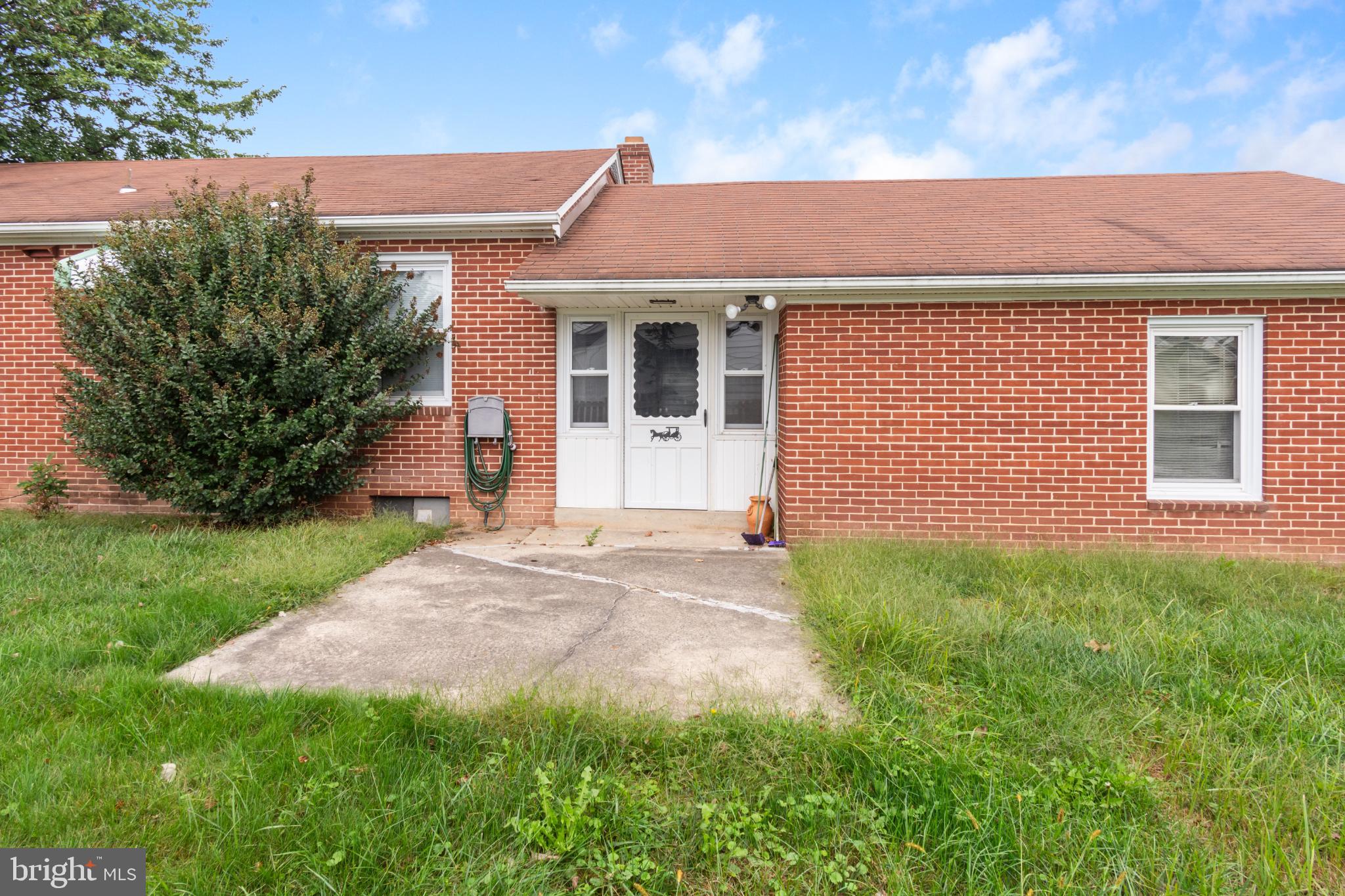 223 Carroll Heights Road Taneytown, MD 21787 - Photo 28 of 32 Charming brick facade with lush greenery.