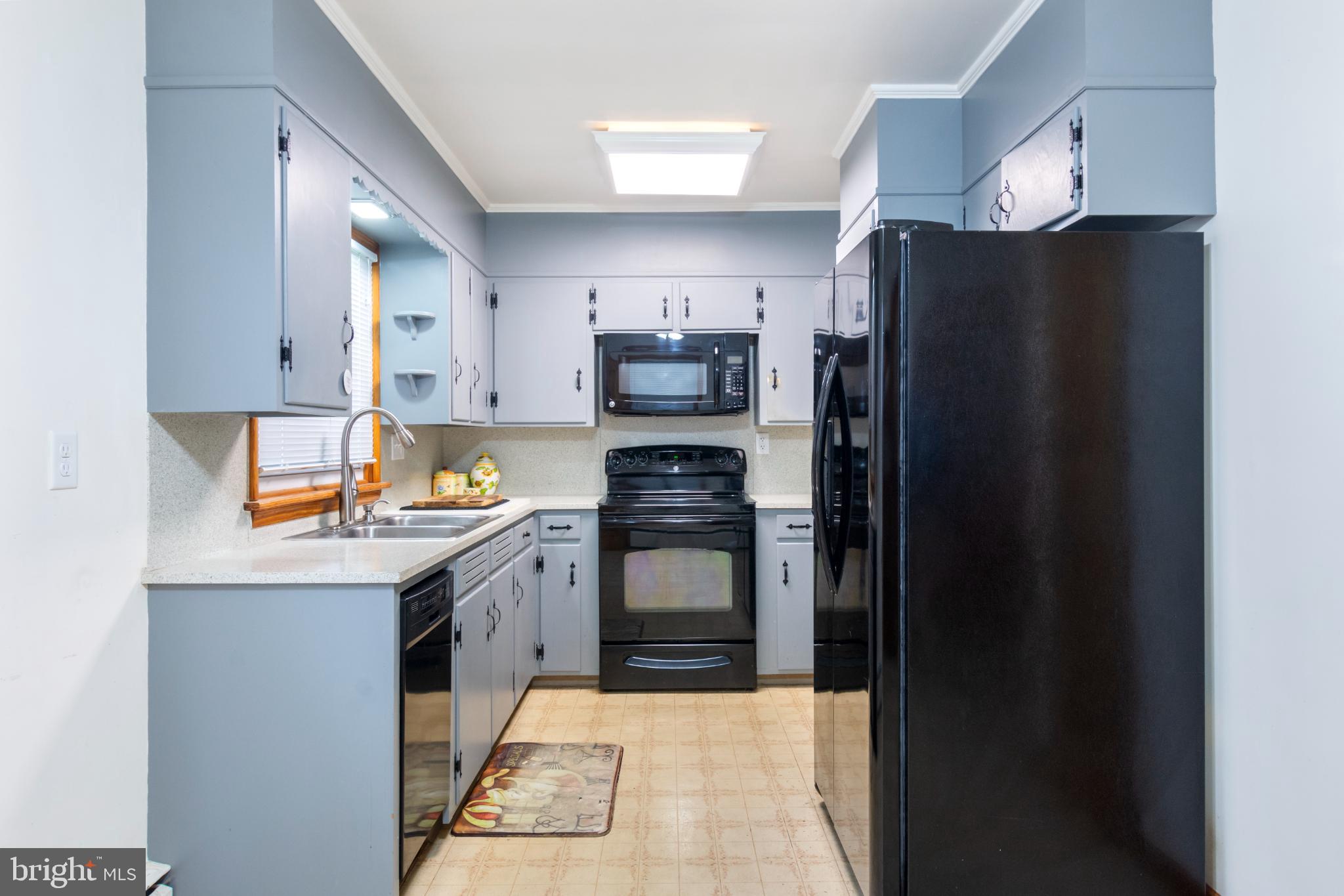 223 Carroll Heights Road Taneytown, MD 21787 - Photo 7 of 32 Modern kitchen with sleek gray cabinetry.