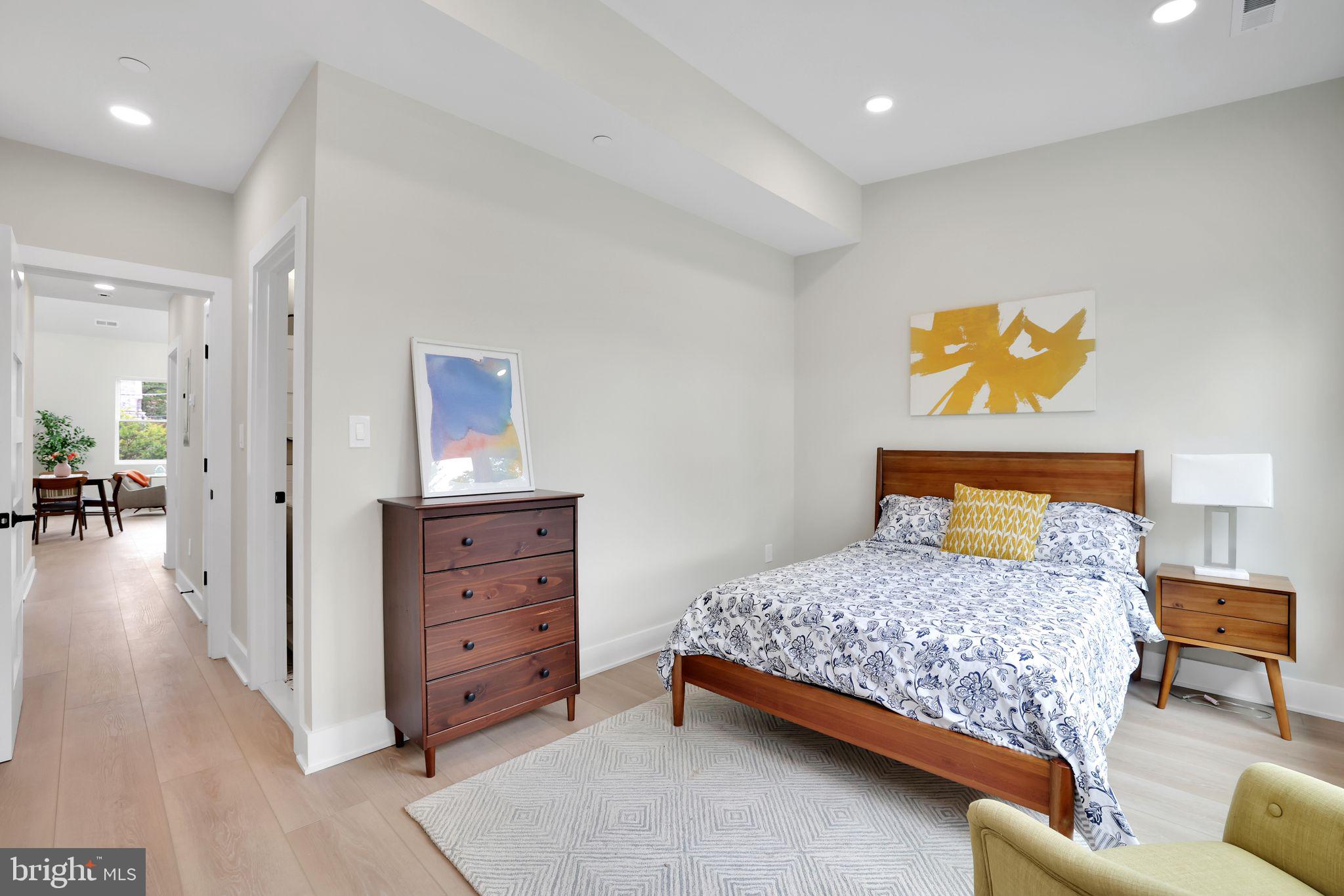 4019 9th Street Northeast, Unit 1 Washington, DC 20017 - Photo 15 of 27 a bedroom with a bed and a couch