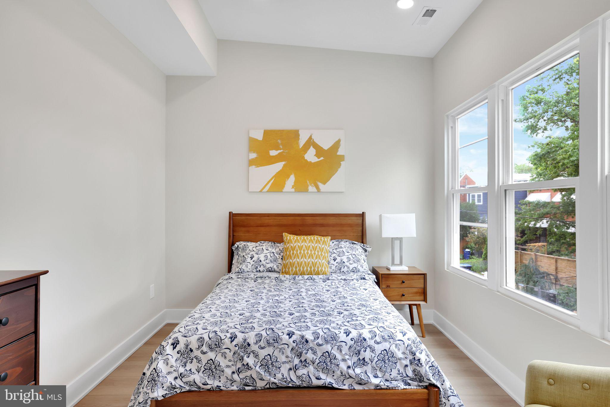 4019 9th Street Northeast, Unit 1 Washington, DC 20017 - Photo 19 of 27 a bed sitting in a bedroom next to a window