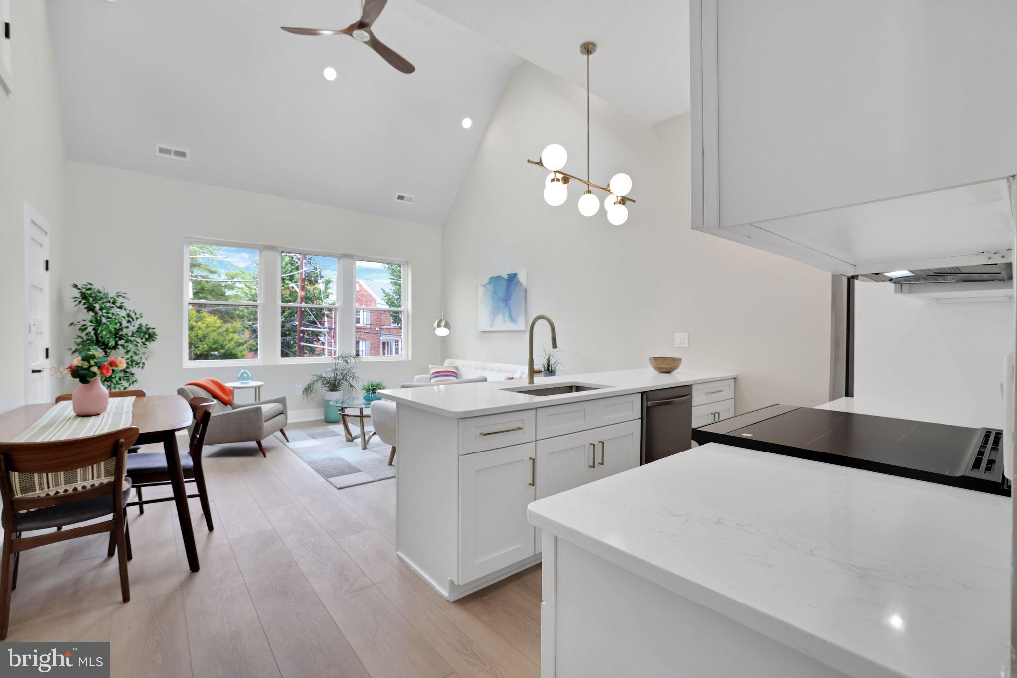 4019 9th Street Northeast, Unit 1 Washington, DC 20017 - Photo 4 of 27 a living room with stainless steel appliances kitchen island furniture and a chandelier