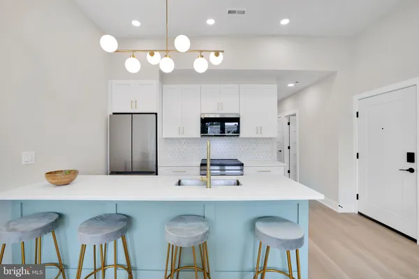 a kitchen with a table and chairs in it