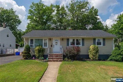 a front view of house with a garden