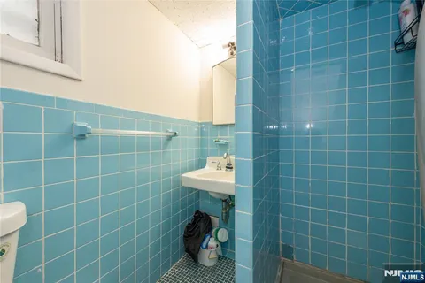 a bathroom with a sink a toilet and a mirror