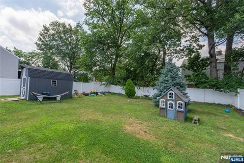 a backyard of a house with wooden floor and fence