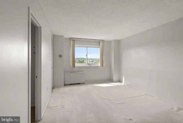 a view of an empty room with a window