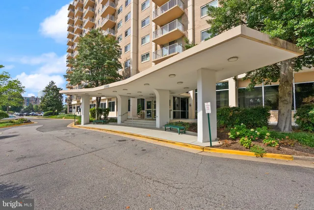 front view of house with a yard and potted plants